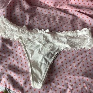 Small white silky panties with lace trim and bows